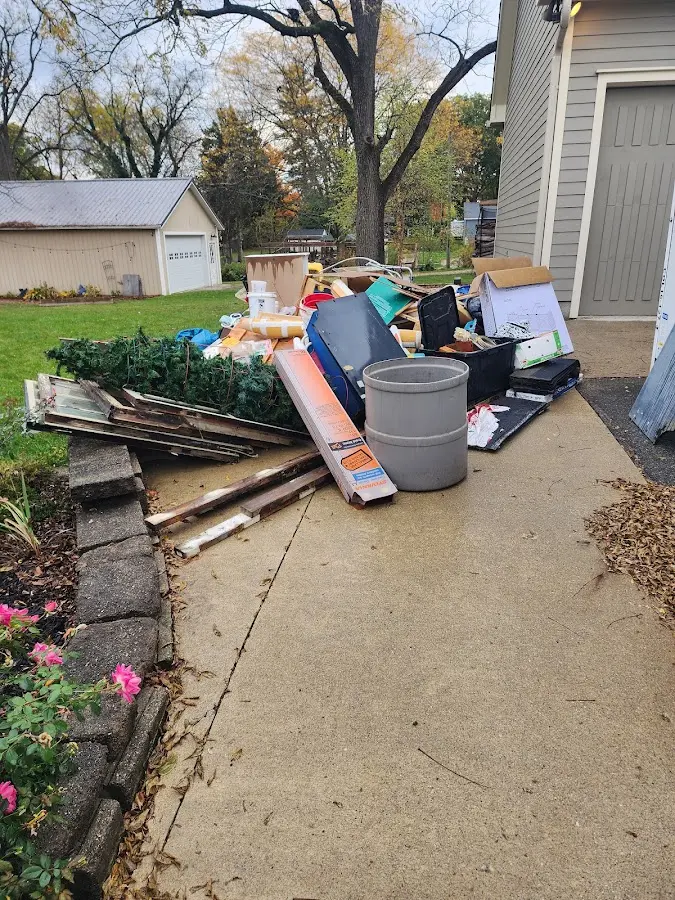 Dumpster being loaded with debris for Estate Cleanout Dumpster Rental in Boulevard Park